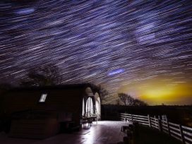 A cabin with a deck and a tripod at Creuddyn Llanfihangel-y-Creuddyn near Aberystwyth