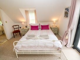 A bedroom with a bed and bedside table at North Studdock Cottage Angle near Pembroke