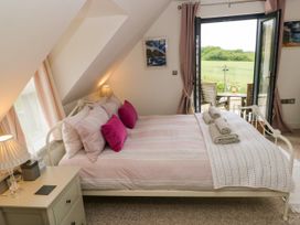 A bedroom with a bed and a view to the outside at North Studdock Cottage Angle near Pembroke
