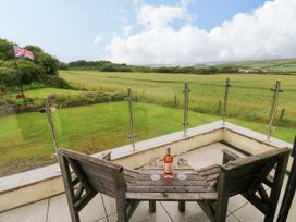 An outdoor seating area with a table and chairs at North Studdock Cottage Angle near Pembroke