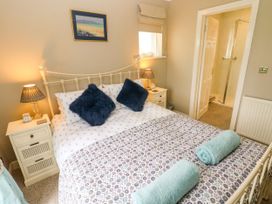 A bedroom with a bed and bedside tables at North Studdock Cottage Angle near Pembroke