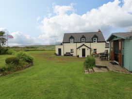 An outdoor view of a house with a garden at North Studdock Cottage, Angle near Pembroke
