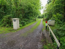 A pathway with gates and a sign at North Studdock Cottage Angle near Pembroke