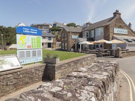An outdoor view of the Castle pub and welcome sign at Driftwood Lodge Hasguard Cross near Broad Haven