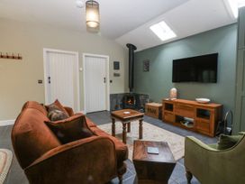 A living room with sofa and television at The Old Tannery Beaumaris