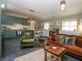 A living room with kitchen cabinets and a sofa at The Old Tannery in Beaumaris