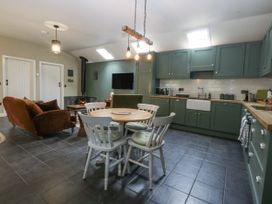 A kitchen with a dining table and chairs at The Old Tannery in Beaumaris