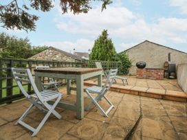 An outdoor area with a table and chairs at The Old Tannery Beaumaris