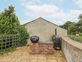 A patio area with a grill and barbecue at The Old Tannery Beaumaris