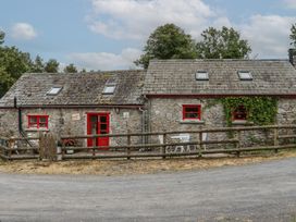 A cottage with red door and windows at The Dairy Ardfinnan, County Tipperary