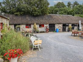 An outdoor area with a building and seating arrangements at The Dairy in Ardfinnan, County Tipperary