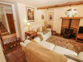 A living room with a fireplace and sofa at White House in Shap