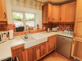 A kitchen with a sink, dishwasher, and countertop at White House in Shap