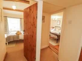 A corridor leading to two bedrooms at White House in Shap
