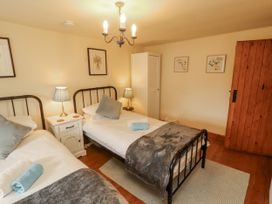 A bedroom with two beds and nightstands at White House in Shap
