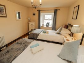 A bedroom with two beds and a dresser at White House in Shap