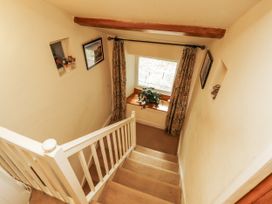 A staircase with a window and pictures at White House in Shap