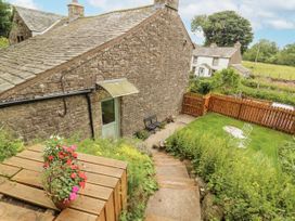 An outdoor garden area with steps and seating at White House in Shap