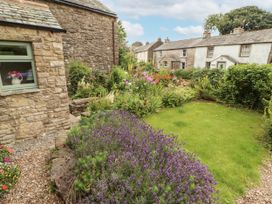A garden with flowers and a pathway at White House in Shap