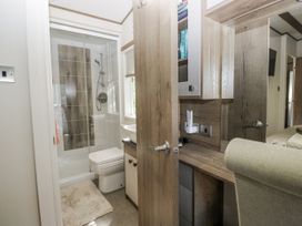 A bathroom with a shower, toilet, and sink at Lilac Lodge in Carnforth