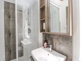 A bathroom with a shower and sink at Lilac Lodge in Carnforth