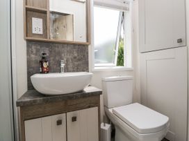 A bathroom with a basin and toilet at Lilac Lodge in Carnforth