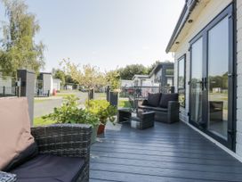 An outdoor seating area with chairs and a table at Lilac Lodge in Carnforth