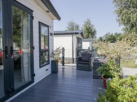 An outdoor area with seating and plants at Lilac Lodge Carnforth