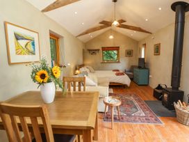 A studio with a bed and dining table at Brambly Cabin in Crediton