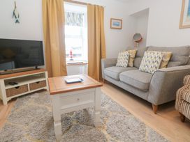 A living room with a sofa and television at Foundry Cottage In Hayle Harbour, Hayle