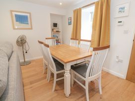 A dining room with a table and chairs at Foundry Cottage In Hayle Harbour Hayle