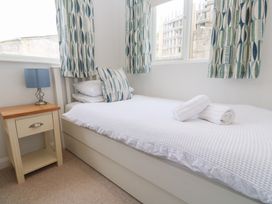 A bedroom with a single bed and bedside table at Foundry Cottage In Hayle Harbour Hayle