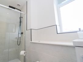 A bathroom with a shower, toilet, and sink at Foundry Cottage In Hayle Harbour, Hayle