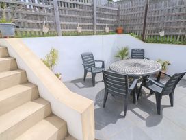 A patio area with a table and chairs at Foundry Cottage In Hayle Harbour, Hayle