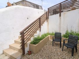 A garden with stairs and chairs at Foundry Cottage In Hayle Harbour, Hayle