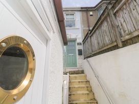 A staircase leading to a front door at Foundry Cottage In Hayle Harbour Hayle