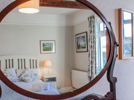 A bedroom with a bed and lamp at Waders in Salcombe
