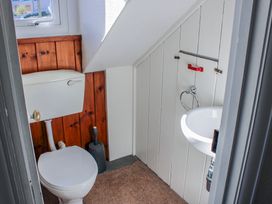 A bathroom with a toilet and sink at Waders in Salcombe