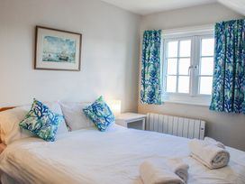 A bedroom with a bed and window at Waders Salcombe