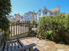An outdoor area featuring a bench and houses at Waders in Salcombe
