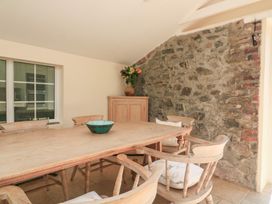 A dining room with a large table and chairs at Wayside near Kingsbridge