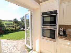 A kitchen with a door leading to a garden at Wayside near Kingsbridge