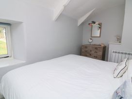 A bedroom with a bed and dresser at Wayside near Kingsbridge