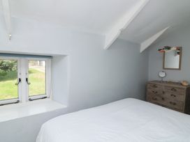 A bedroom with a bed, window, and dresser at Wayside near Kingsbridge