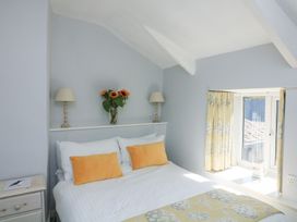 A bedroom with a bed and window at Wayside near Kingsbridge