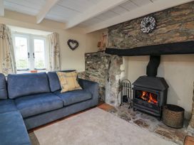 A living room with a fireplace and sofa at Wayside near Kingsbridge