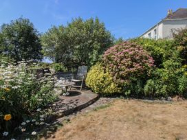 A garden with flowers and seating area at Wayside near Kingsbridge