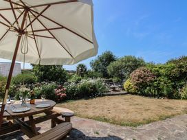 A garden with patio furniture and flowers at Wayside near Kingsbridge