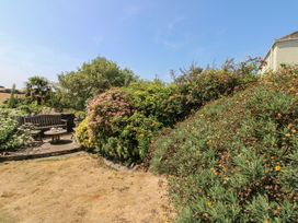 A garden with a bench and table at Wayside near Kingsbridge