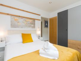 A bedroom with a bed and map on the wall at Branock, Tor Down Quarry St Breward